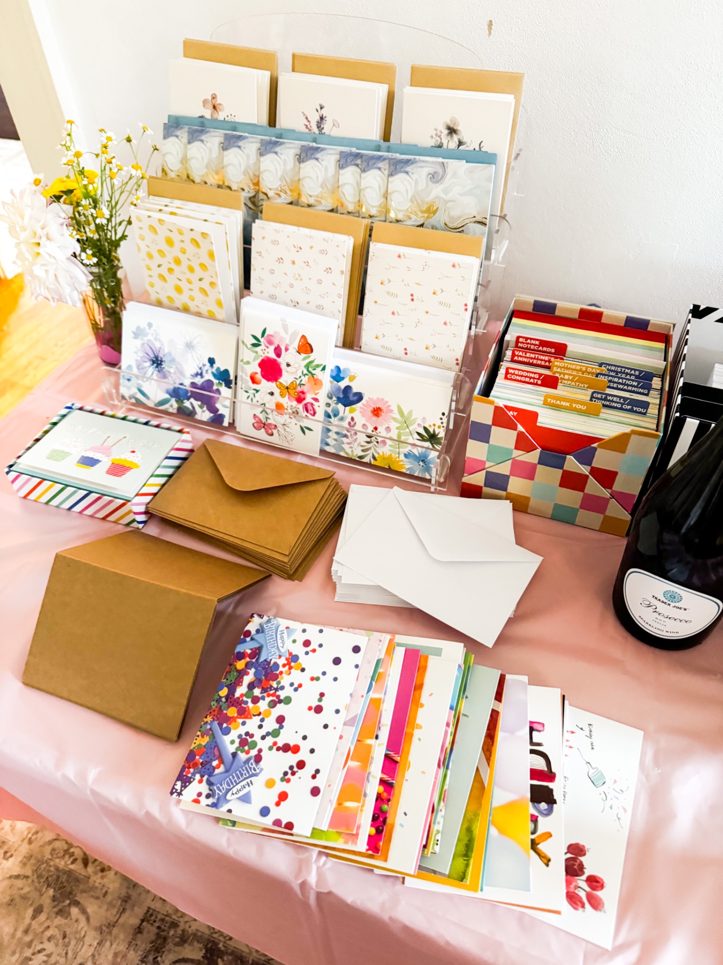 Beautifully curated card station with florals, envelopes, and prosecco